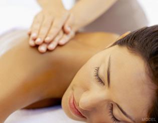 Woman With Eyes Closed Getting a Back Massage