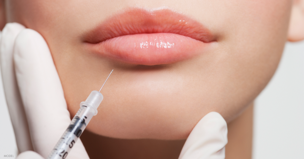 Young woman receiving lip injections