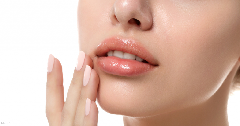 A woman happy about getting lip fillers with JUVÉDERM.