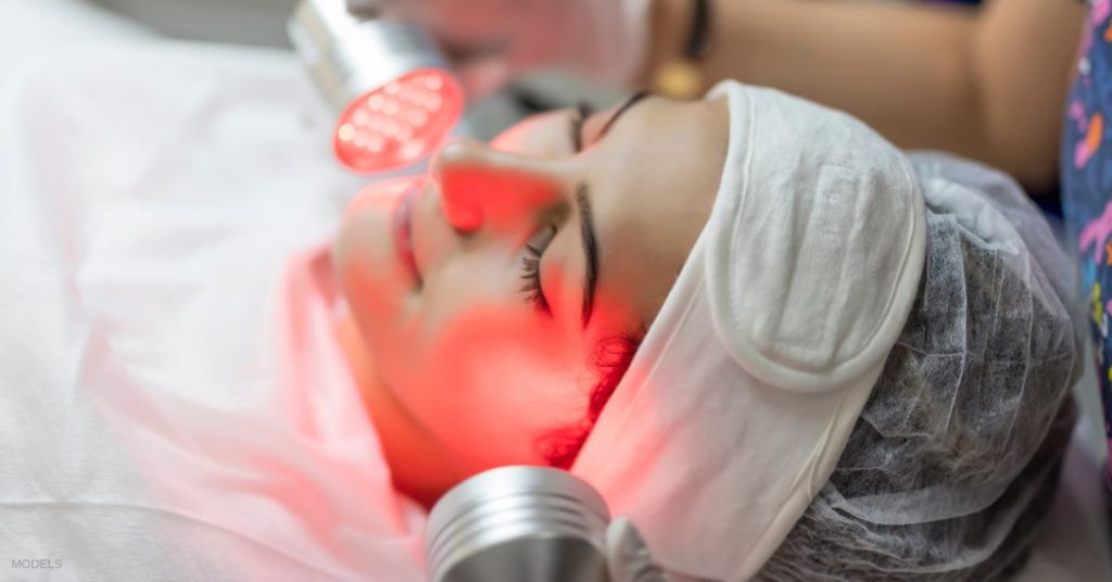 A woman getting a red light therapy treatment. (Models)